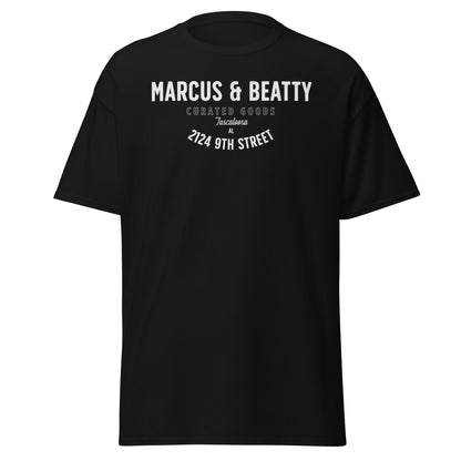 Front view of the Marcus & Beatty Classic Logo Tee in 100% cotton, front logo print with small Dual Flame mark near neckline on back, unisex cut, black.