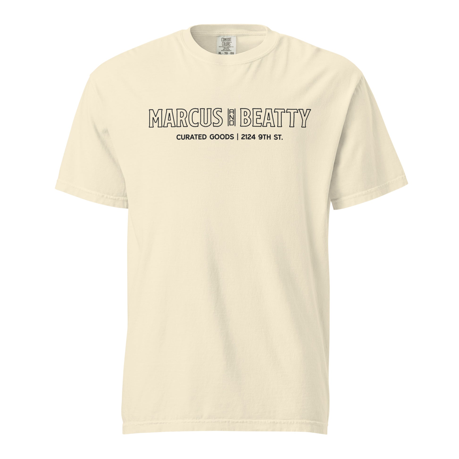 Front View of the Marcus & Beatty Storefront Logo Tee on Comfort Colors garment-dyed cotton, with front logo print inspired by storefront, unisex relaxed fit, Ivory color.