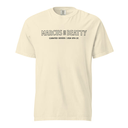 Front View of the Marcus & Beatty Storefront Logo Tee on Comfort Colors garment-dyed cotton, with front logo print inspired by storefront, unisex relaxed fit, Ivory color.