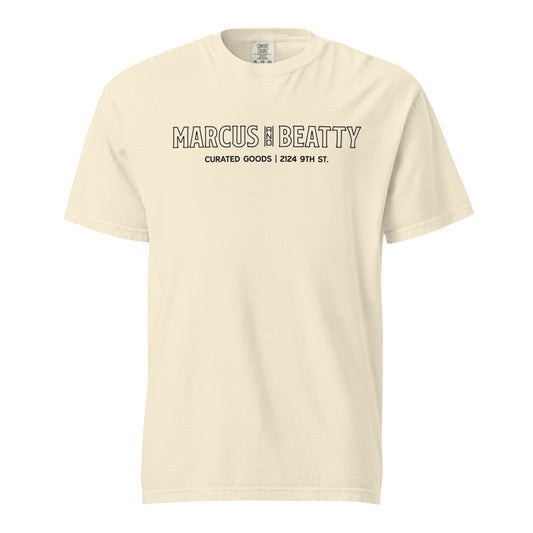 Front View of the Marcus & Beatty Storefront Logo Tee on Comfort Colors garment-dyed cotton, with front logo print inspired by storefront, unisex relaxed fit, Ivory color.