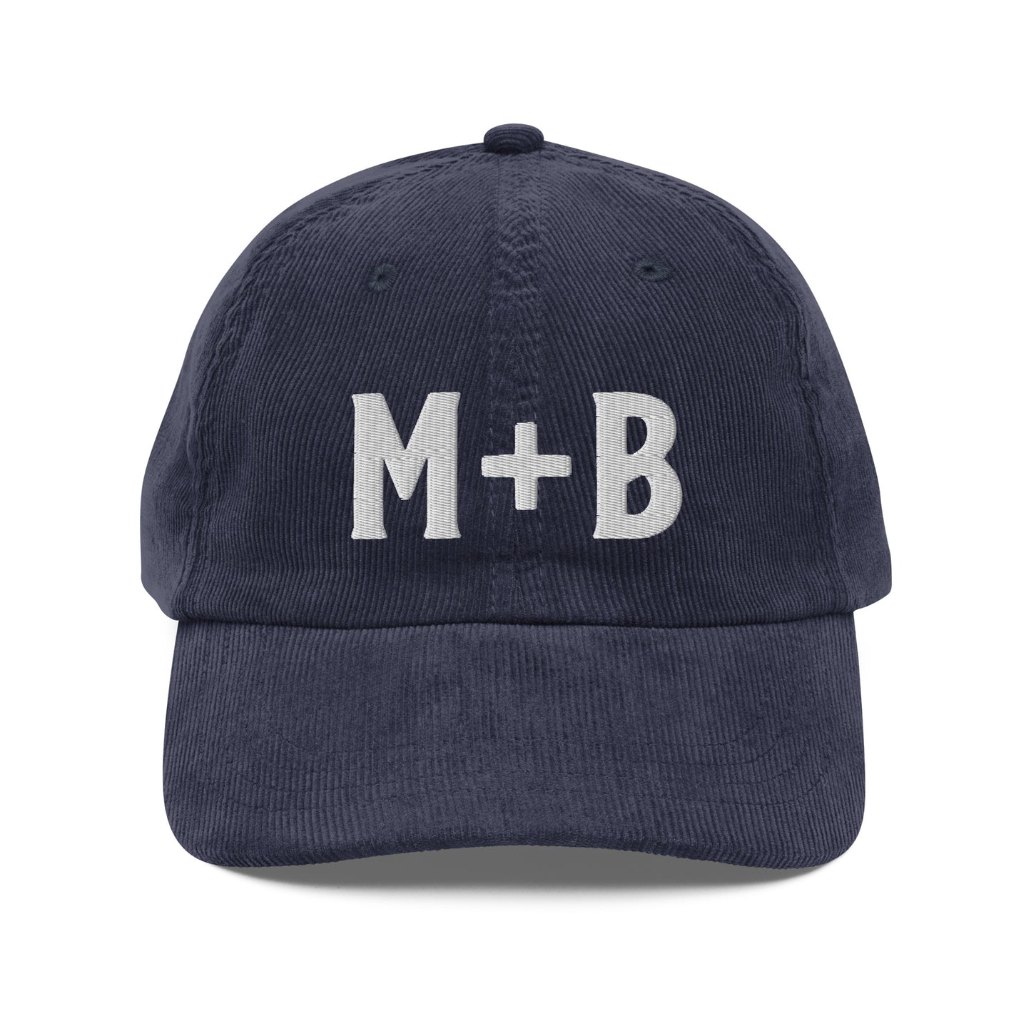 Front View of the Marcus & Beatty navy vintage corduroy cap, embroidered 'M + B' logo in white, adjustable gold buckle strap, unstructured low-profile fit.